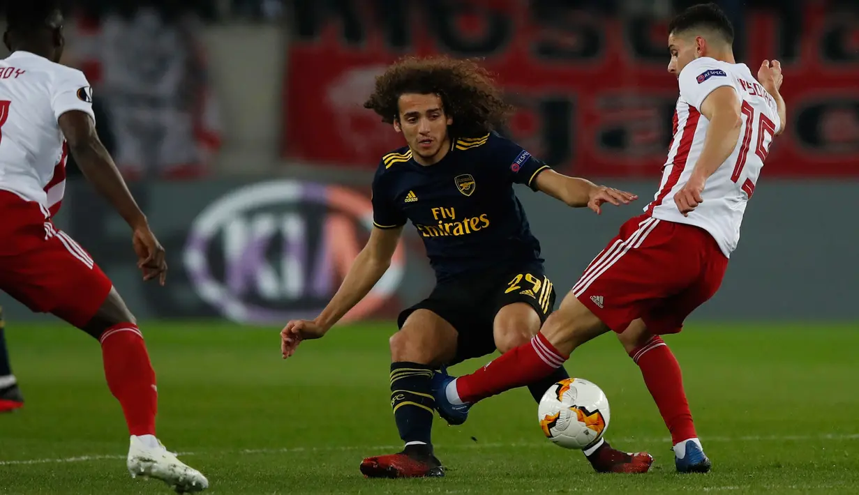 Pemain Olympiakos Piraeus, Svetozar Markovic berebut bola dengan gelandang Arsenal Matteo, Guendouzi pada leg pertama babak 32 besar Liga Europa di Georgios Karaiskakis Stadium, Kamis (20/2/2020). Arsenal susah payah menaklukkan Olympiakos Piraeus 1-0. (AP/Thanassis Stavrakis)