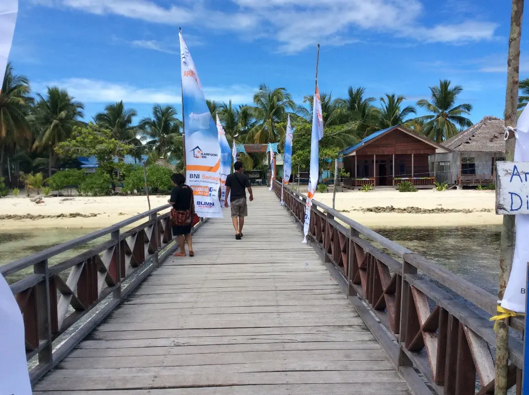 Jembatan dari dermaga di kampung Arborek yang biasa dimanfaatkan perahu motor bersandar. (foto : liputan6.com/katharina janur)