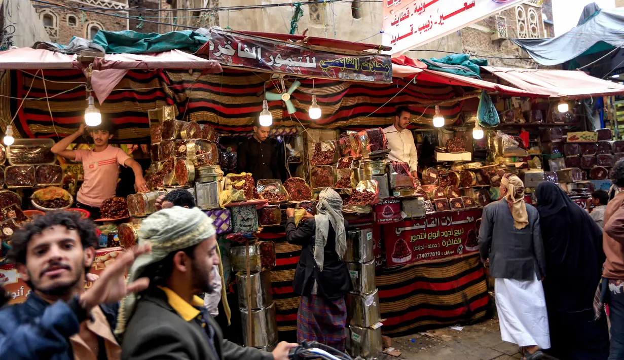 Sejumlah pedagang kurma menunggu pembeli di sebuah pasar di kota tua Sanaa, Yaman, Sabtu (11/5/2019). Kurma menjadi salah satu pilihan umat muslim sebagai menu buka puasa di bulan suci Ramadan. (Photo by Mohammed HUWAIS / AFP)