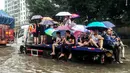 Warga menumpang truk saat banjir melanda Xinxiang, Provinsi Henan, Tiongkok, (9/7). Sedikitnya 420 ribu warga dari 4 kota setempat, termasuk ibukota Fuzhou terpaksa dievakuasi ke tempat yang lebih aman. (REUTERS)