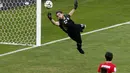 Penjaga gawang Iran, Alireza Haghighi, mencoba menggapai bola hasil tendangan keras pemain Argentina, Lionel Messi, saat berlaga di babak penyisihan Piala Dunia Grup F di Stadion Mineirao, Belo Horizonte, Brasil (21/6/2014). (REUTERS/Leonhard Foeger)