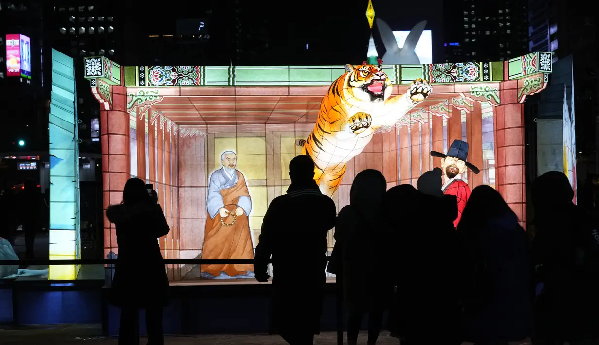 Pengunjung melihat lentera yang menyala selama perayaan Tahun Kelinci 2023 mendatang di Lapangan Gwanghwamun, Seoul, Korea Selatan, Senin (19/12/2022). Festival Lentera ini akan berlangsung dari 19-31 Desember 2022. (AP Photo/Ahn Young-joon)
