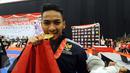 Ahmad Zigi Zaresta tersenyum usai memastikan kemenangan di final Junior Kata Male di WKF World Junior, Cadet and U-21 Championship 2015 di ICE Serpong, Kamis (12/11/2015). Zigi menyumbang emas pertama bagi Indonesia. (Liputan6.com/Helmi Fithriansyah)