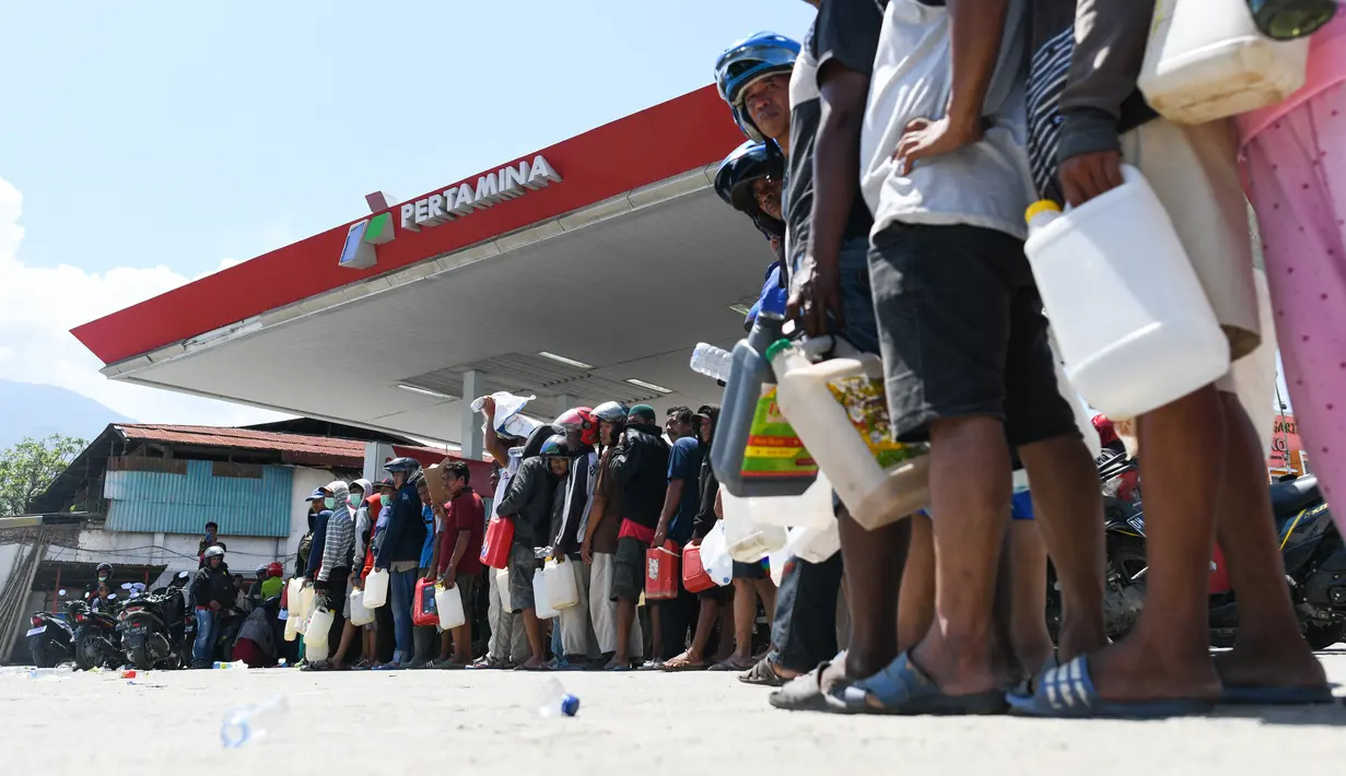 Korban gempa dan tsunami mengantre untuk mendapatkan bahan bakar minyak (BBM) di SPBU Kota Palu, Sulawesi Tengah, Senin (1/10). Warga rela mengantre panjang di SPBU karena BBM sangat dibutuhkan untuk mobilisasi. (Jewel Samad/AFP)