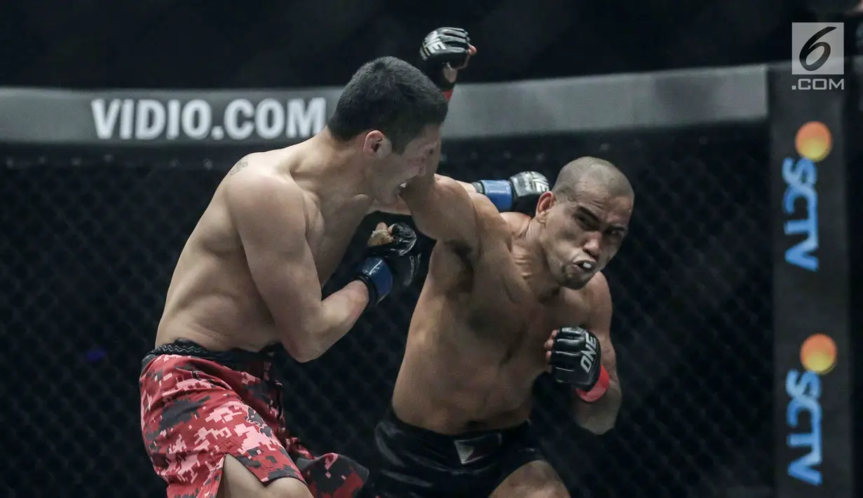 Petarung Filipina, Rene Catalan (kanan) dan petarung China, Peng Xue Wen (kiri) melakukan pukulan saat berlaga pada One Championship di Jakarta, Sabtu (20/1). Petarung Rene Catalan menang atas Peng Xue Wen. (Liputan6.com/Faizal Fanani)