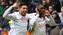 Pemain Liverpool, Christian Benteke (kanan) merayakan gol bersama rekannya Emre Can saat melawan Crystal Palace pada lanjutan liga Inggris 2015-2016 di Stadion Selhurts Park, Minggu (6/3/2016) malam WIB. (AFP/Glyn Kirk)