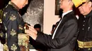 Presiden Joko Widodo menerima penyematan pin dan keris dari Sultan Deli, Tuanku Mahmud Lamantjiji Perkasa Alam saat menerima gelar Tuanku Sri Indera Utama Junjungan Negeri dari Kesultanan Deli di Istana Maimoon, Minggu (6/10). (Liputan6.com/HO/Biropers)