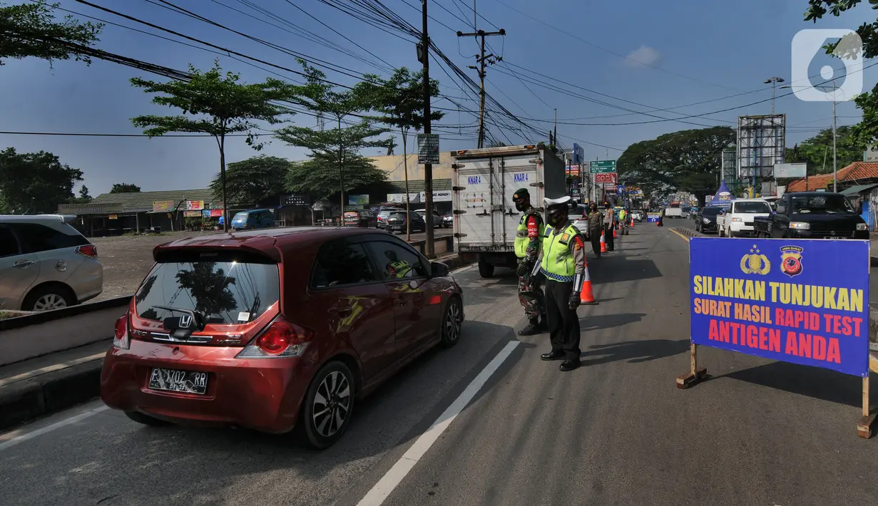 Petugas gabungan melakukan penyekatan di check point penyekatan arus mudik di kawasan Pasar Mudik, Bogor, (7/5/2021). Penyekatan pemudik pada jalur alternatif Parung diberlakukan jelang Lebaran guna mengantisipasi risiko peningkatan kasus COVID-19. (merdeka.com/Arie Basuki)