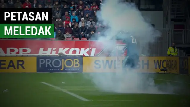 Berita video insiden kiper Ajax, Andre Onana, hampir kena ledakan petasan yang dilempar dari tribun suporter saat laga kontra FC Utrecht dalam lanjutan Eredivisie 2018-2019, Minggu (23/12/2018).