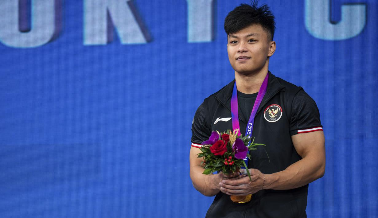 Lifter putra Indonesia Rahmat Erwin Abdullah saat upacara pengalungan medali final 73 kilogram Grup A Asian Games 2022 di Xiaoshan Sports Centre Gymnasium, Hangzhou, China, Selasa (3/10/2023). (AP Photo/Louise Delmotte)