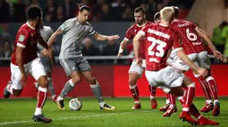 Pemain Manchester United, Zlatan Ibrahimovic menggiring bola dengan kawalan pemain Bristol City pada perempat final Piala Liga Inggris di Ashton Gate, Kamis (21/12). MU tersingkir setelah takluk 1-2 di kandang Bristol City. (Nick Potts/PA via AP)