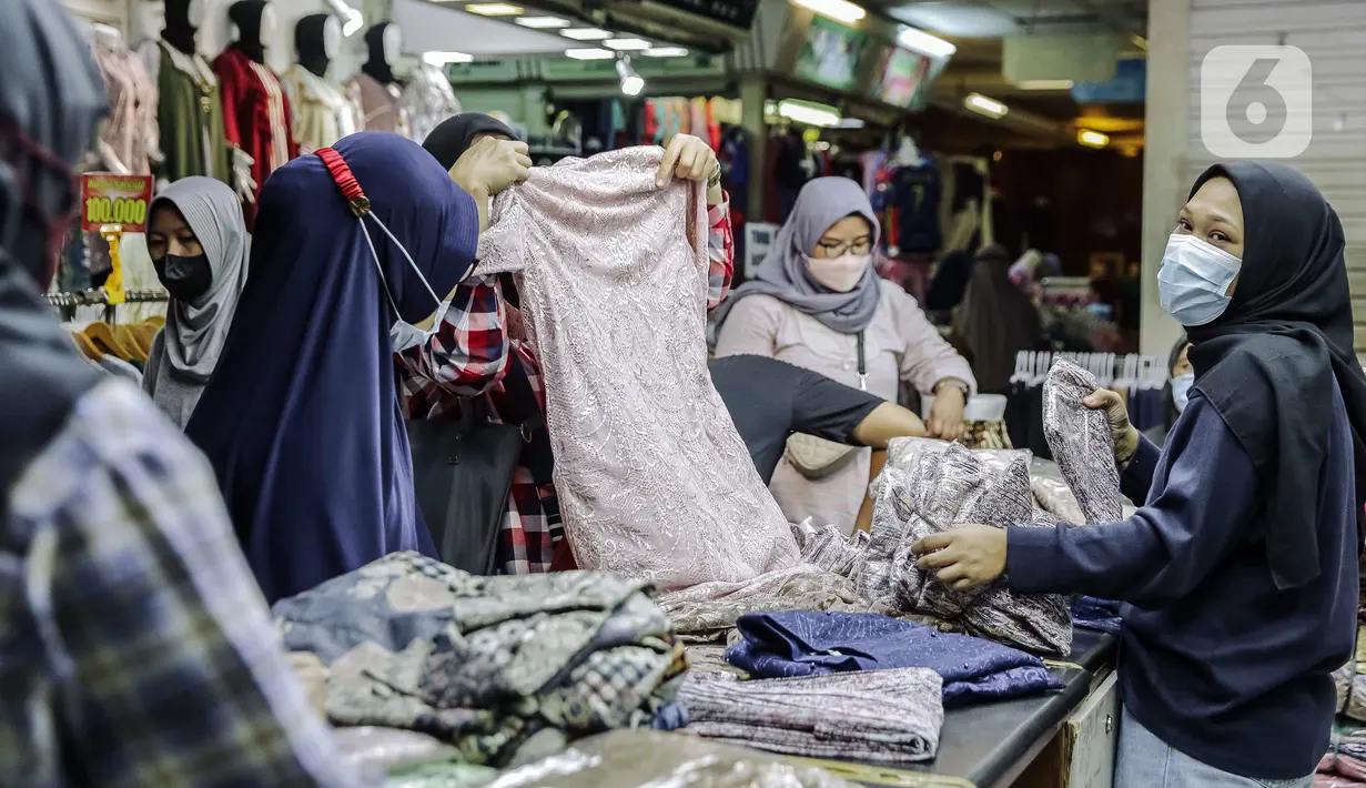 Pedagang melayani pembeli di Pasar Tanah Abang, Jakarta, Minggu (10/10/2021). Dilonggarkannya kebijakan PPKM di Jakarta membuat aktivitas perdagangan di Pasar Tanah Abang kembali bangkit. (Liputan6.com/Faizal Fanani)