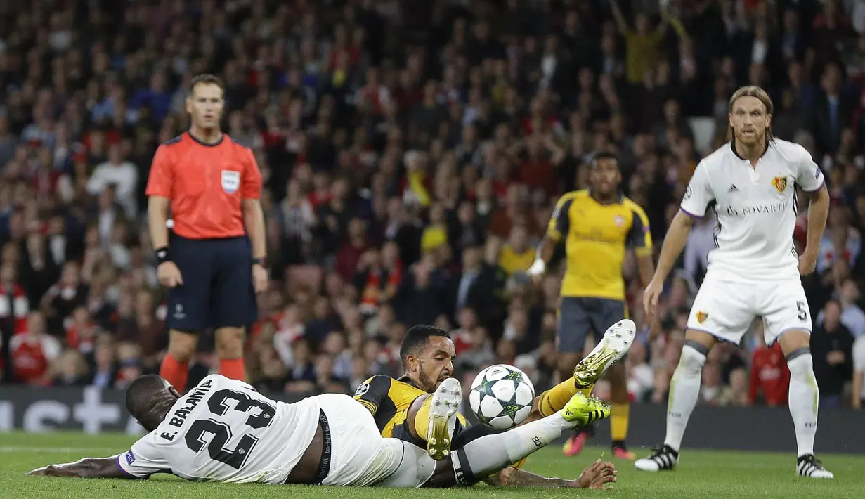 Pemain Basel, Eder Balanta (kiri) menghadang laju pemain Arsenal, Theo Walcott pada laga grup A Liga Champions di Emirates stadium, London, Kamis (29/9/2016)dini hari WIB. (AP/Alastair Grant)