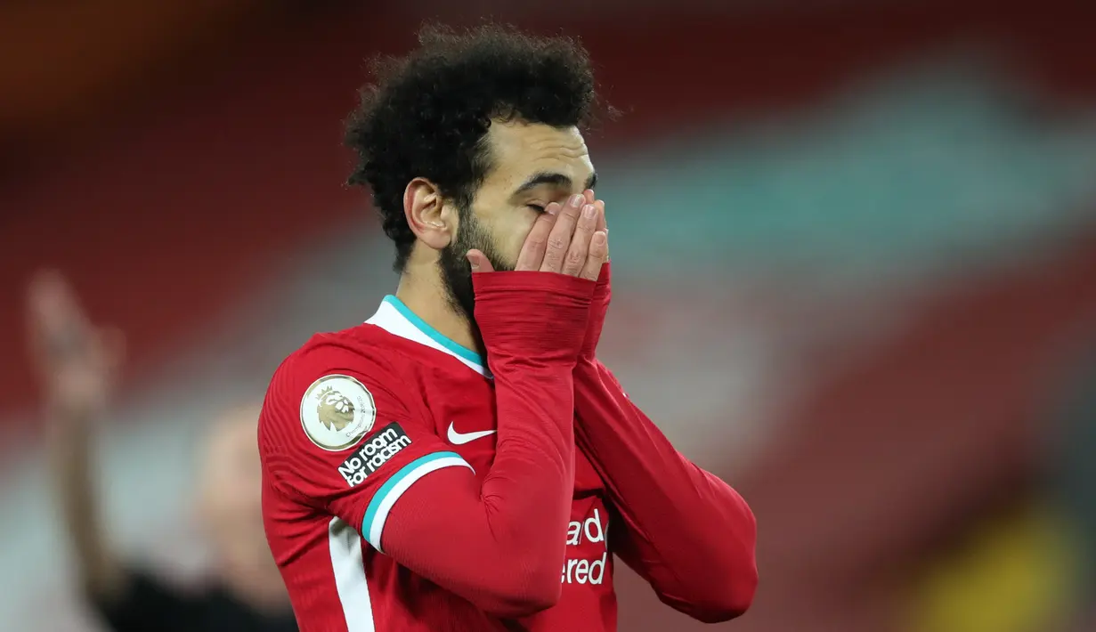 Reaksi gelandang Liverpool, Mohamed Salah saat menjamu Burnley pada laga pekan ke-19 Liga Inggris 2020-2021 di Stadion Anfield, Jumat dini hari WIB (22/1/2021). Liverpool kalah tipis 0-1 atas Burnley sekaligus menelan kekalahan ketiga musim ini. (Clive Brunskill/POOL/AFP)