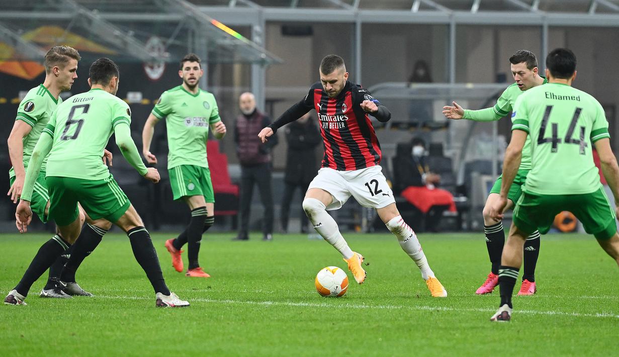 Penyerang AC Milan, Ante Rebic, berebut bola dengan gelandang Celtic, Kristoffer Vassbakk Ajer, pada laga lanjutan Liga Europa di Stadion San Siro, Jumat (4/12/2020) dini hari WIB. AC Milan menang 4-2 atas Celtic. (AFP/Vincenzo Pinto)