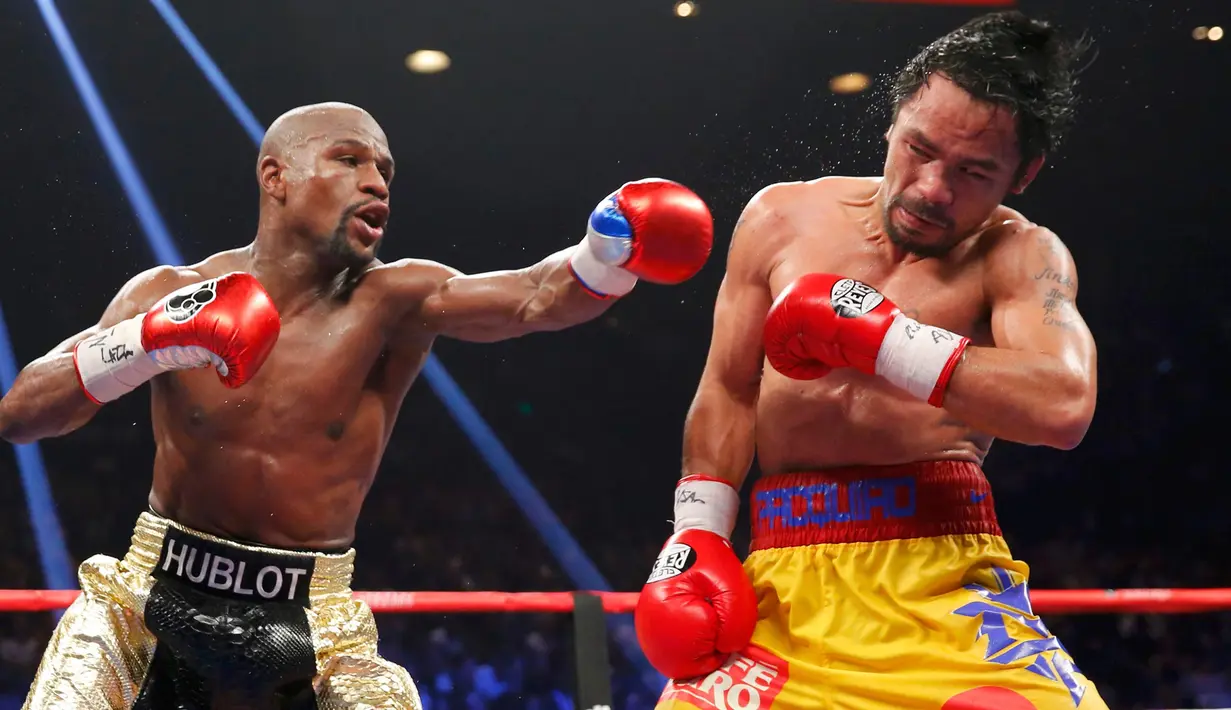 Floyd Mayweather Jr berusaha memukul wajah Manny Pacquiao saat pertandingan kelas welterweight di MGM Grand Garden Arena, Las Vegas, Nevada, Minggu (3/5/2015). Floyd Mayweather berhasil manang angka atas Manny Pacquiao. (REUTERS/Steve Marcus)