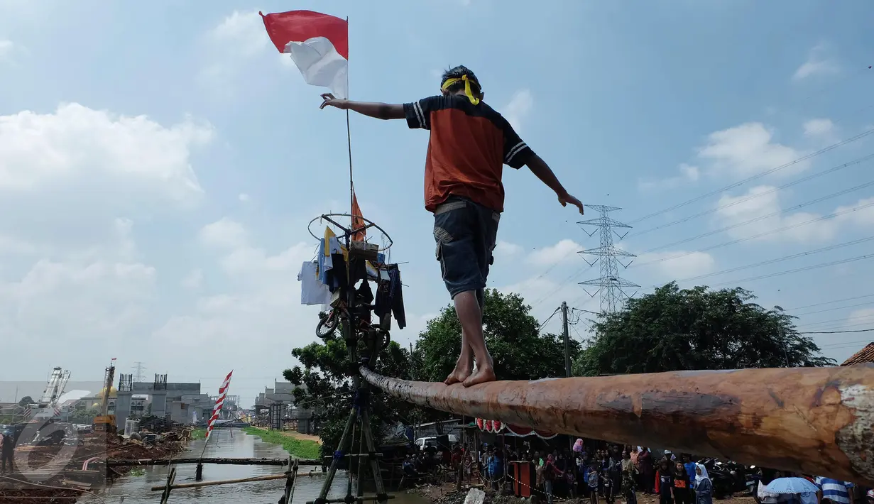 Peserta mengikuti lomba Jalan Pinang di Kalimalang, Jakarta Timur, Senin (17/8). Lomba tersebut dalam rangka menyemarakkan perayaan HUT RI ke-71. (Liputan6.com/Johan Tallo)