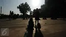 Warga duduk santai menyaksikan proses gerhana matahari di sekitar Taman Ismail Marzuki, Jakarta, Rabu (9/3/2016). Di Jakarta, fenomena gerhana matahari 90% bisa diamati selama 2,11 menit. (Liputan6.com/Helmi Fithriansyah)   