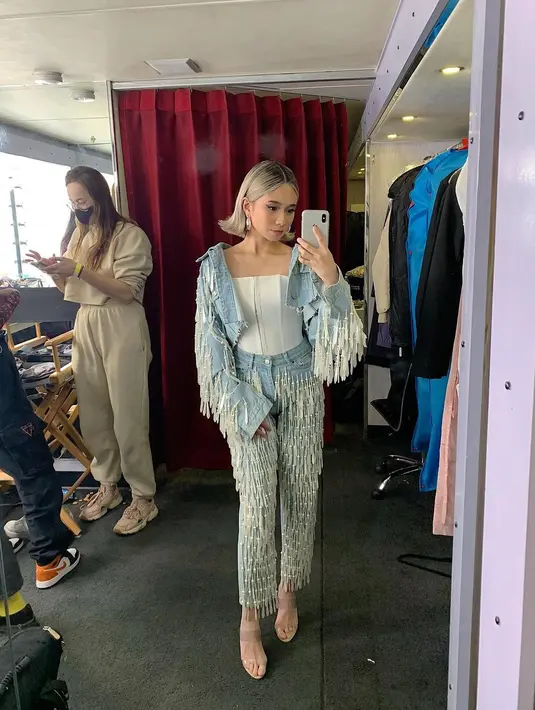 Berpose di backstage, Niki terlihat mengenakan outfit super nyentrik dari jeans. Crop top putih polos sebagai innerwear, ditumpuk denim dan dipadu dengan celana panjang denim. Foto: Instagram.