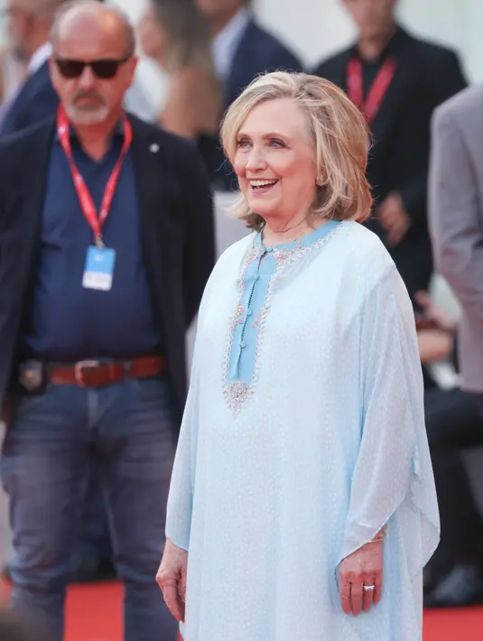 Hillary Clinton berpose untuk fotografer setibanya pada pemutaran perdana film 'White Noise' dan upacara pembukaan Venice Film Festival ke-79 di Venesia, Italia, 31 Agustus 2022. Aksen garis leher manik-manik dari gaun yang mengalir dan beberapa gelang perak meningkatkan penampilan Hillary di karpet merah. (Photo by Vianney Le Caer/Invision/AP)