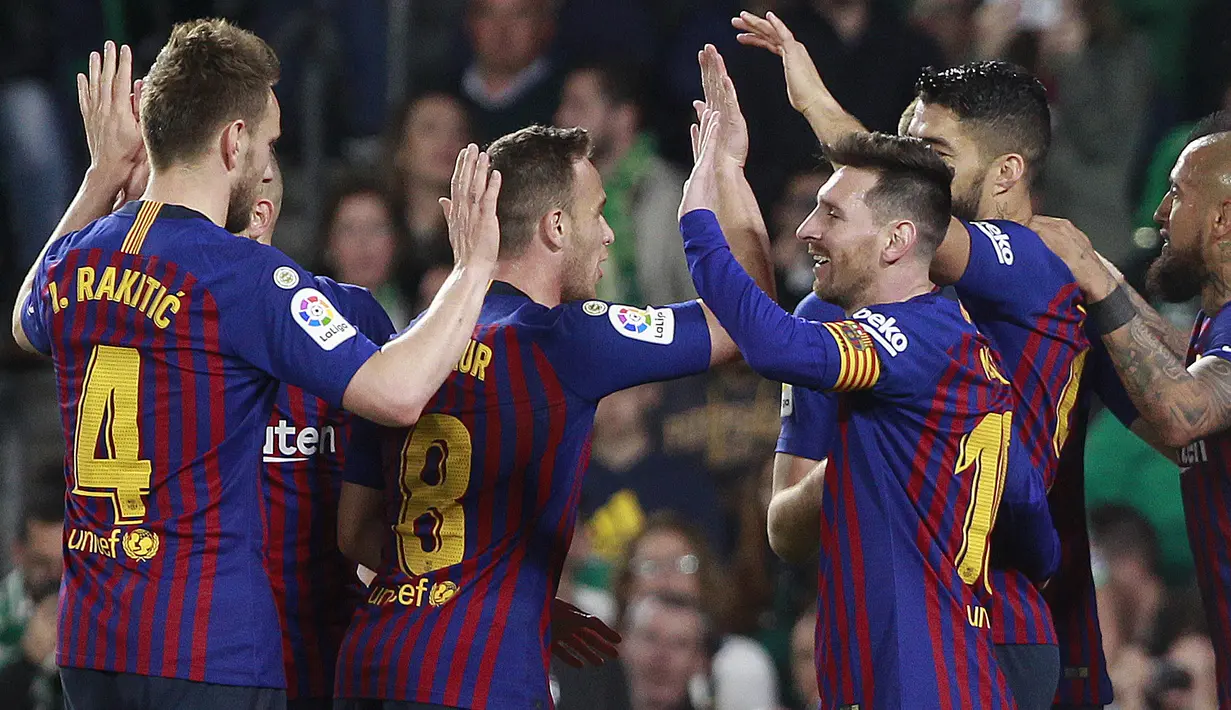 Para pemain Barcelona merayakan gol yang dicetak oleh Lionel Messi ke gawang Real Betis pada laga La Liga 2019 di Stadion Benito Villamarin, Minggu (17/3). Barcelona menang 4-1 atas Real Betis. (AP/Miguel Morenatti)