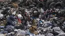 Anjing berkumpul di tumpukan besar pakaian bekas yang menutupi gurun pasir di dekat lingkungan La Mula di Alto Hospicio, Chile, Senin (13/12/2021). Chile adalah importir besar pakaian bekas, dan barang-barang yang tidak terjual dibuang di sini. (AP Photo/Matias Delacroix)