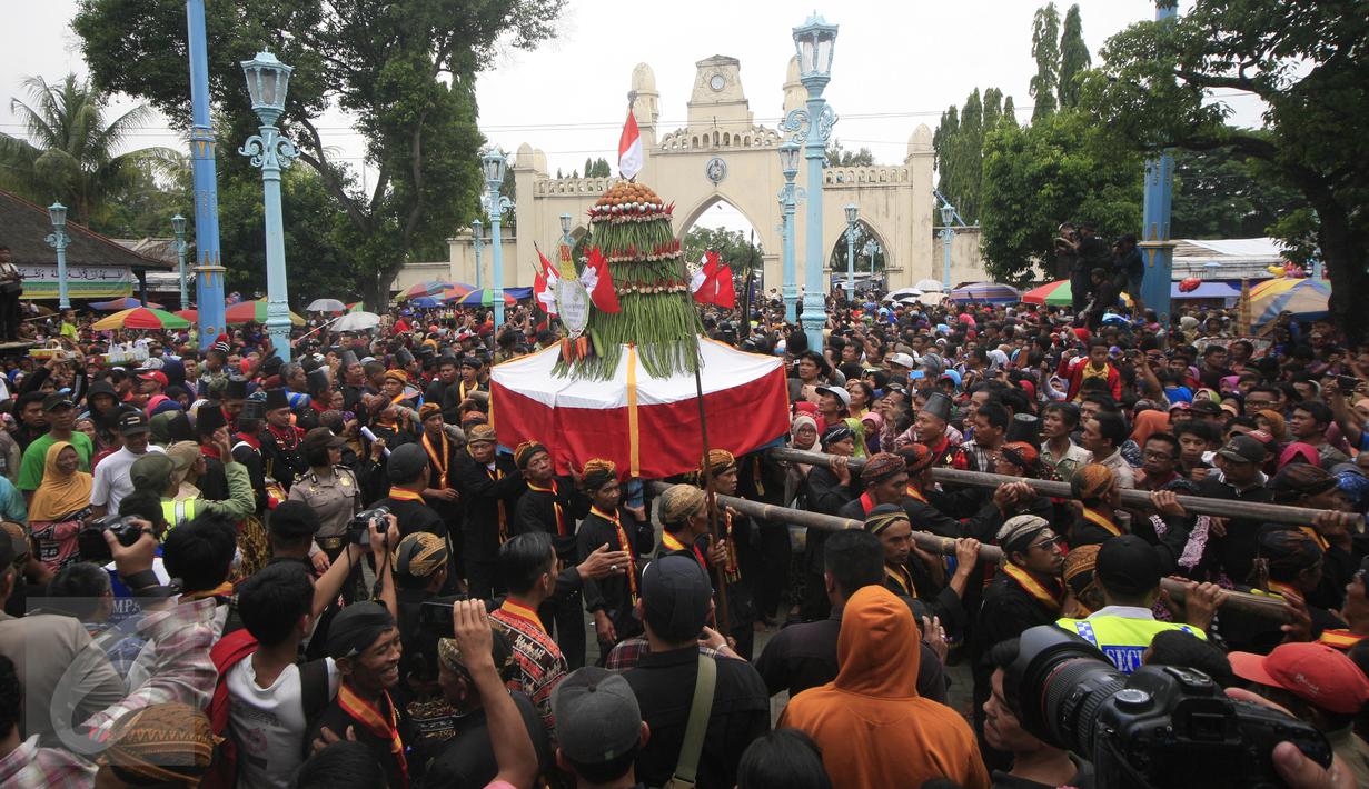 Puluhan abdi dalem Keraton Surakarta menggotong Gunungan Sekaten di pelataran Masjid Agung, Solo, Kamis (24/12). Keluarnya gunungan menandai puncak acara Sekaten yang digelar untuk peringatan Maulid Nabi Muhammad. (Boy Harjanto)