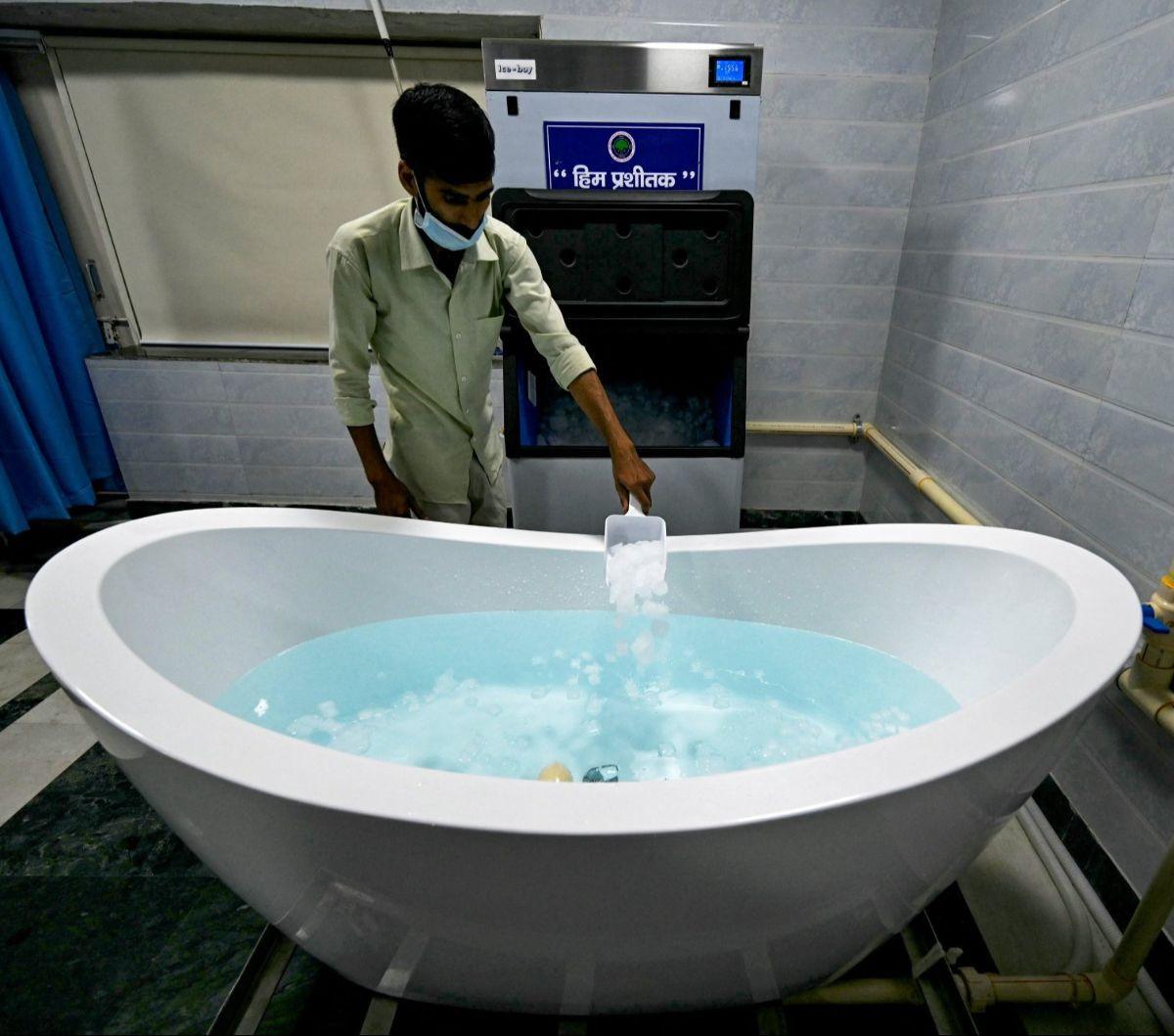 Seorang petugas menyiapkan air es pada bathub khusus di Rumah Sakit (RS)&nbsp;Ram Manohar Lohia, New Delhi, India, pada 30 Mei 2024. RS Ram Manohar Lohia berinovasi dengan menyediakan bathub khusus untuk merawat pasien yang menderita heat stroke di tengah