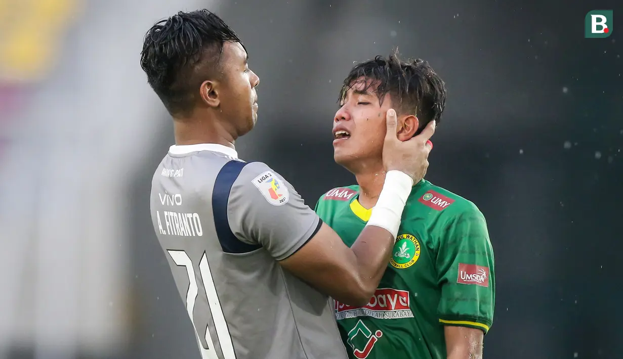 Kiper PSG Pati, Annas Fitranto (kiri) berusaha menghibur pemain Hizbul Wathan FC, M. Ghozy usai berakhirnya laga matchday ke-10 Grup C Liga 2 2021/2022 di Stadion Manahan, Solo, Selasa (30/11/2021). (Bola.com/Bagaskara Lazuardi)