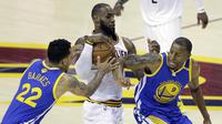 Pemain Cleveland Cavaliers, LeBron James, berusaha melewati pemain Golden State Warriors, Matt Barnes dan Andre Iguodala pada Gim 3 Final NBA 2017, Rabu (7/6/2017). Warriors menang 118-113. (AP/Tony Dejak)