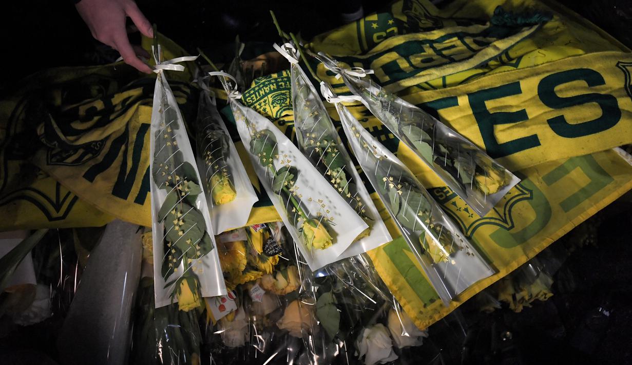 Mantan bintang FC Nantes, Emiliano Sala dikabarkan meninggal dunia usai pesawat yang ditumpanginya hilang dari kontak, selasa (22/1). Hal tersebut membuat pendukung FC Nantes larut dalam rasa duka. (AFP/Loic Venance)