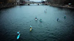 Peserta mendayung melewati aliran sunga- sungai selama perlombaan dayung dan perahu di Sungai Seine di Paris, Perancis, Minggu, (2/12). Acara ini diikuti oleh ribuan peserta dari berbagai kota di Paris. (AFP)