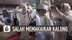 Bukannya memakaikan kalung ke mempelai pria, ibu-ibu ini justru memakai kalung sendiri saat tradisi pernikahan berlangsung.