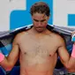 Petenis Spanyol Rafael Nadal mengeringkan diri dengan handuk saat istirahat pada pertandingan melawan Victor Estrella Burgos dari Republik Dominika di kejuaraan tenis Australia Terbuka di Melbourne, Australia, (15/1). (AP Photo / Vincent Thian)