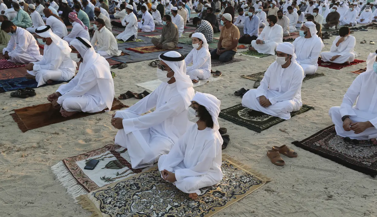 Umat Muslim yang mengenakan masker untuk meredam penyebaran wabah virus corona melaksanakan sholat Idul Fitri menandai akhir bulan suci Ramadhan di Dubai, Uni Emirat Arab, Kamis (13/5/2021). (AP Photo / Kamran Jebreili)