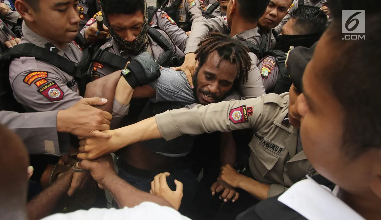 Massa yang tergabung dalam Front Rakyat Indonesia untuk West Papua (FRI-WP) dan Aliansi Mahasiswa Papua (AMP) terlibat aksi saling dorong dengan polisi saat unjuk rasa di Jalan Medan Merdeka Barat, Jakarta, Selasa (15/8). (Liputan6.com/Immanuel Antonius)