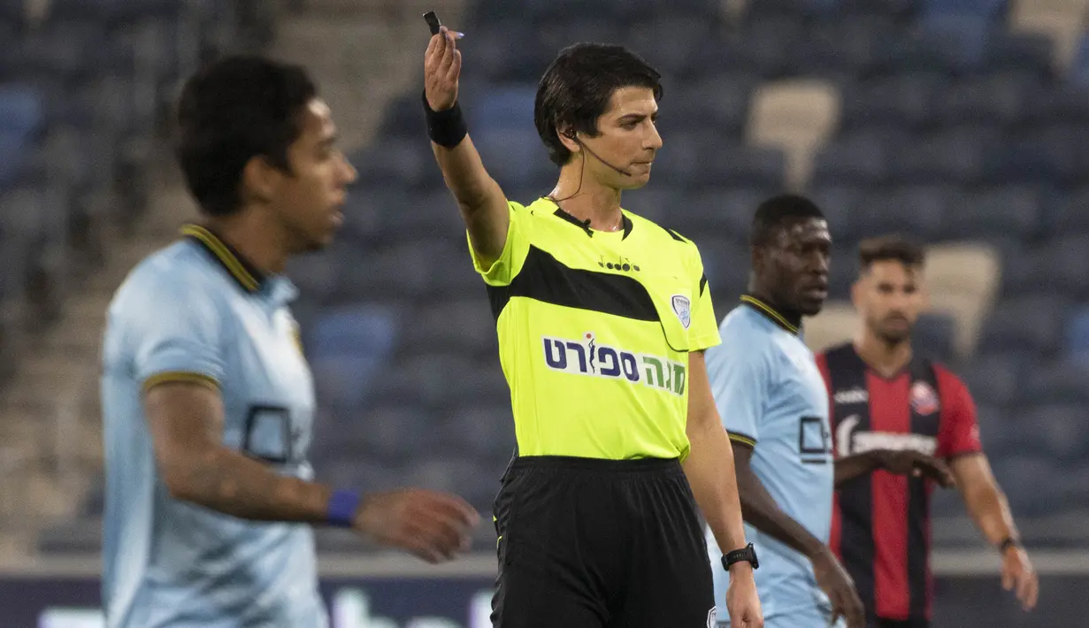 Wasit Sapir Berman memimpin pertandingan Liga Premier Israel antara Hapoel Haifa vs Beitar Jerusalem di kota Haifa, Senin (3/5/2021). Wasit sepak bola transgender pertama Israel turun ke lapangan untuk pertama kalinya sejak tampil di depan umum sebagai seorang wanita.  (AP Photo/Sebastian Scheiner)
