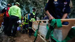 Tim penyalamat keluar dari gua saat mencari tim sepak bola remaja yang hilang di provinsi Chiang Rai, Thailand (26/6). Mereka terjebak saluran air sempit sejauh 15 meter. (AFP/Thai News Pix/Krit Phromsakla Na Sakolnakorn)