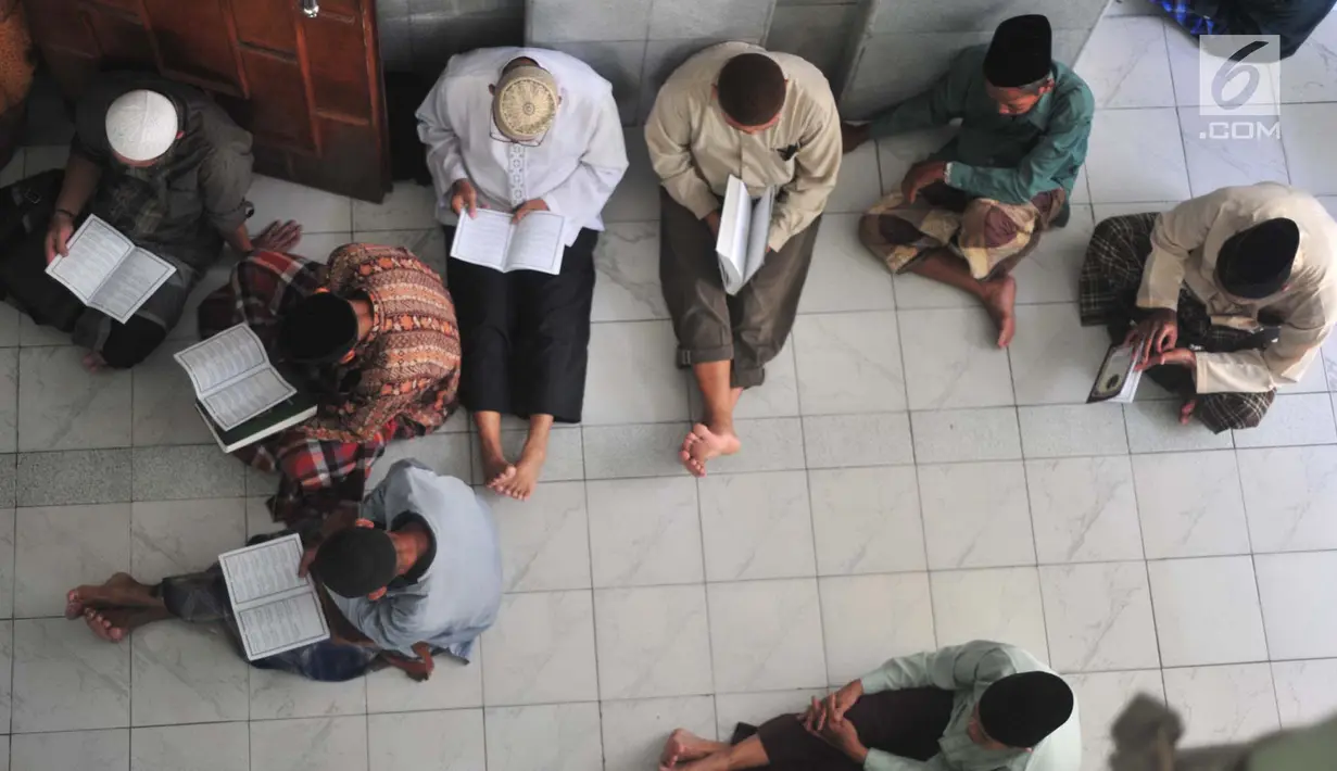 Sejumlah jemaah pria terlihat serius saat mengikuti tadarus Alquran di Masjid Kauman, Semarang, Jawa Tengah, Rabu (8/5/2019). (Liputan6.com/Gholib)