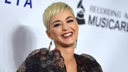Penyanyi Katy Perry tersenyum saat berpose menghadiri pesta Gala Musicares Person of The Year 2019 di Los Angeles (8/2). Katy Perry tampil menawan mengenakan gaun hitam bermotif kembang dengan belahan hingga paha terbuka. (AP Photo/Jordan Strauss)
