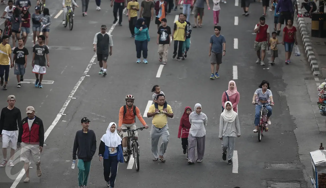 Sejumlah peserta Car Free Day (CFD) berjalan santai di kawasan Bundaran HI, Jakarta, Minggu (8/5/2016). Walaupun libur panjang, warga Jakarta masih antusias melakukan aktivitas di hari bebas berkendaraan untuk berolahraga. (Liputan6.com/Faizal Fanani)