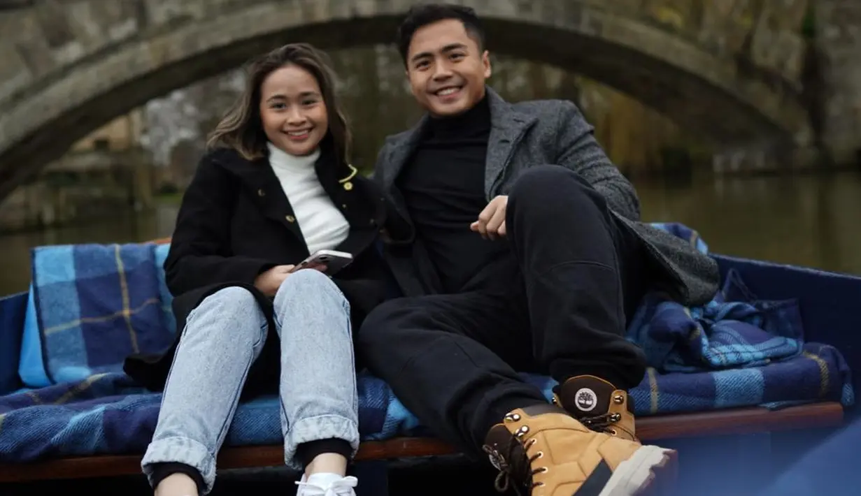 <p>Kali ini keduanya memamerkan potret liburan. Berpose di atas kapal, Gritte memilih mengenakan turtleneck putih dengan coat hitam, dipadu celana jeans dan sneakers putih. Sedangkan Arif mengenakan turtleneck hitam dengan coat abu-abu, celana jeans, dan boots. Foto: Instagram.</p>
