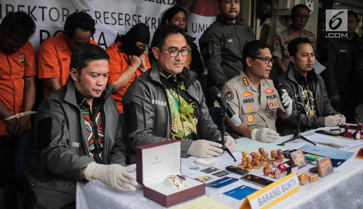 Kabid Humas Polda Metro Jaya Kombes Pol Argo Yuwono (dua kanan) memberi keterangan kasus sindikat kejahatan properti saat rilis di Jakarta, Jumat (9/8/2019). Polisi menyita barang bukti berupa sertifikat hak milik, tanda terima, dan kop surat. (Liputan6.com/Faizal Fanani)
