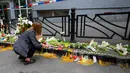 Ribuan orang berkumpul di lingkungan sekolah dasar itu pada malam hari untuk meletakkan bunga dan menyalakan lilin. (AP Photo/Darko Vojinovic)