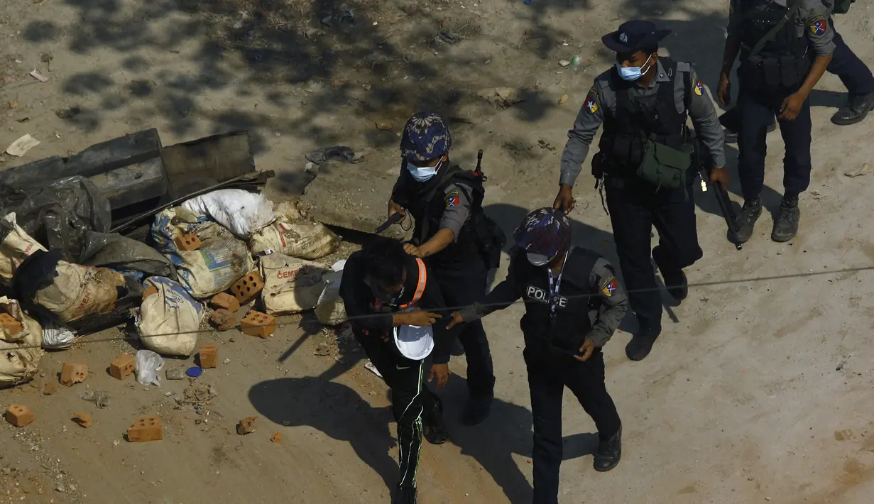 Polisi membawa seorang pengunjuk rasa saat mereka menahannya selama demonstrasi menentang kudeta militer di Yangon, Sabtu (6/3/2021). PBB Myanmar mengecam tindakan  kekerasan aparat terhadap pendemo dalam aksi damai menolak kudeta  militer. (AFP Photo)