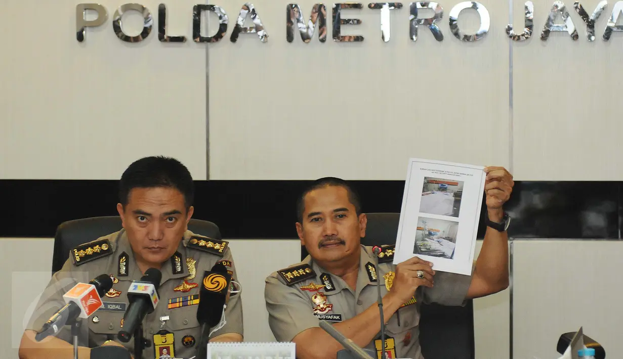 Kabid Dokkes PMJ Kombes Musyafak (kanan) menunjukkan foto kondisi terakhir korban teror (14/1/) lalu saat menggelar jumpa pers di Mapolda Metro Jaya, Jakarta, Sabtu (14/1/2016). Beberapa korban dalam perawatan intensif. (Liputan6.com/Helmi Fithriansyah)