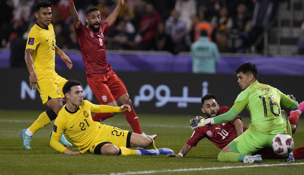 Gelandang Timnas Bahrain, Komail Al Aswad (kedua kanan) berusaha mencetak gol ke gawang Malaysia pada laga kedua Grup E Piala Asia 2023 di Jassim bin Hamad Stadium, Al Rayyan, Qatar, Sabtu (20/1/2024) sore waktu setempat. (AP Photo/Thanassis Stavrakis)