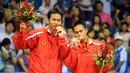 Pemain badminton Indonesia Markis Kido (kanan) dan Hendra Setiawan merayakan dengan medali emas mereka usai mengalahkan pemain badminton China Cai Yun dan Fu Haifeng pada pertandingan final ganda putra Olimpiade Beijing 2008 di Beijing, China, 16 Agustus 2008. (AFP PHOTO/GOH CHAI HIN)