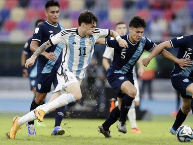 Pemian Timnas Argentina U-20, Matias Soule, berusaha melewati pemain Guatemala, Arian Recinos, pada laga Grup A Piala Dunia U-20 2023 di Estadio Unico Madre de Ciudades, Rabu (24/5/2023). Argentina membungkam Guatemala tiga gol tanpa balas. (AP Photo/Nicolas Aguilera)