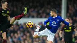 Gelandang Everton, Kevin Mirallas, berebut bola dengan bek Manchester City, John Stones. Meski kalah, City lebih menguasi jalannya laga dengan penguasaan bola mencapai 70 persen. (EPA/Peter Powell)